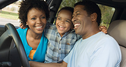 African family sitting inside the car